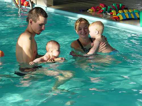babies swimming with adults